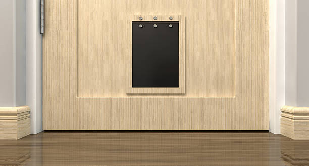 Pet Flap Interior An inside view of a regular black pet flap on a light wood door surrounded by walls walls and wood skirting flapping wings photos stock pictures, royalty-free photos & images