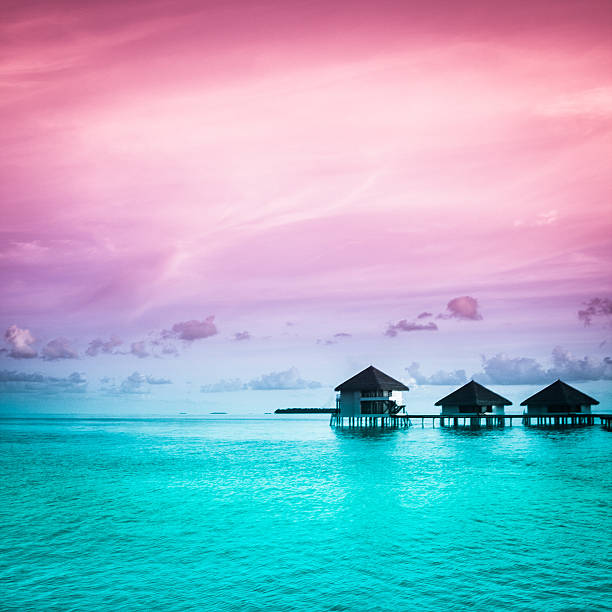 small harbor and jetty under dramatic sky on maldives island, indian ocean.