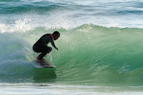 istock Long boarder surfing the waves at sunset 498389689
