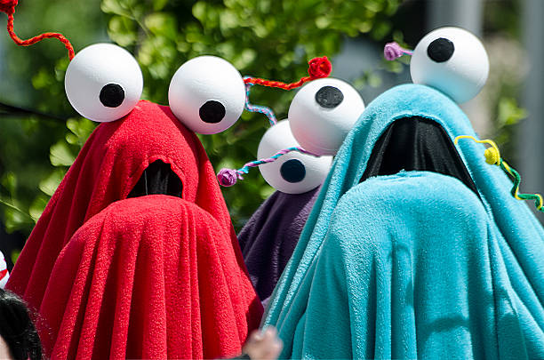 Yip Yip Aliens from Sesame Street San Jose, California, USA - May 24, 2014: Cosplayers dressed as Yip Yip Aliens from Sesame Street. FanimeCon 2014. This is one of many groups of cosplayers (costumed players) that dress as a favorite characters from an anime, manga, video game or comic and gathers on the outdoor plaza in front of the San Jose McEnery Convention Center, San Jose, California, for individual and group photoshoots. FamineCon is held annually over Memorial Day weekend. television show stock pictures, royalty-free photos & images