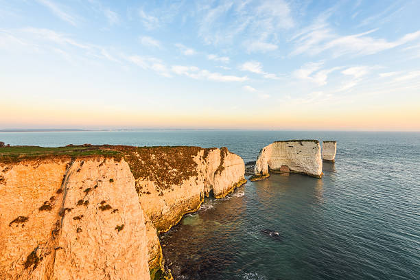 Old Harry Rocks, winter sunrise A cold start at Old Harry Rocks, the start of the world heritage coastline of Dorset, England. old harry rocks stock pictures, royalty-free photos & images