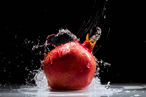 Pomegranate splashing water