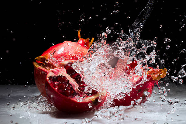 Pomegranate splashing water