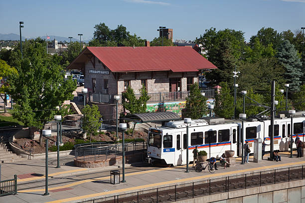 Light rail train at Littleton Station Colorado Littleton, Colorado, USA - June 13, 2014: A southbound RTD light rail train pulls up to the Littleton Station as passengers wait for a northbound train. littleton colorado stock pictures, royalty-free photos & images