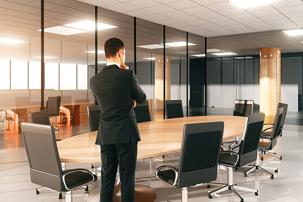 istock Businessman watching on round conference table with chairs in th 498398252