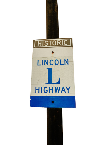 Sign full of cracks marking the historic Lincoln Highway which was the first transcontinental improved highway for automobiles running from New York to San Francisco.