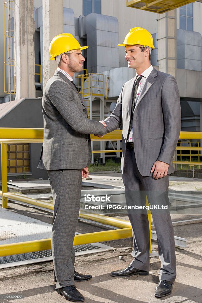 Industrial Engineers on site Full length of two architects greeting on construction site 20-29 Years Stock Photo
