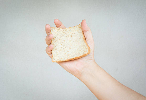 istock sliced whole wheat bread in human hand 498399336