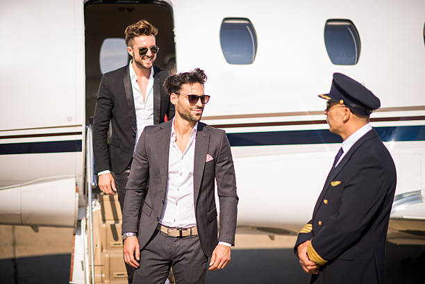 istock Wealthy men leaving private jet airplane 498399476