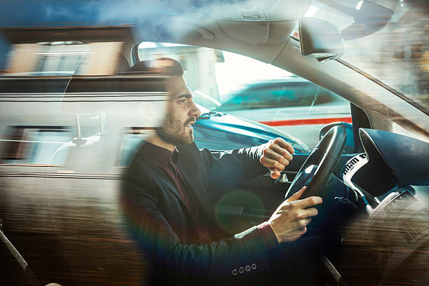 бизнесмен вождения автомобиля - car speed lifestyles night стоковые фото и изображения
