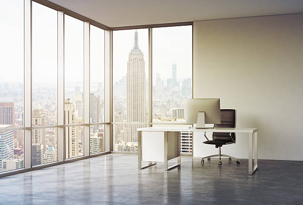 istock workplace in office with sunset New York view 498400088