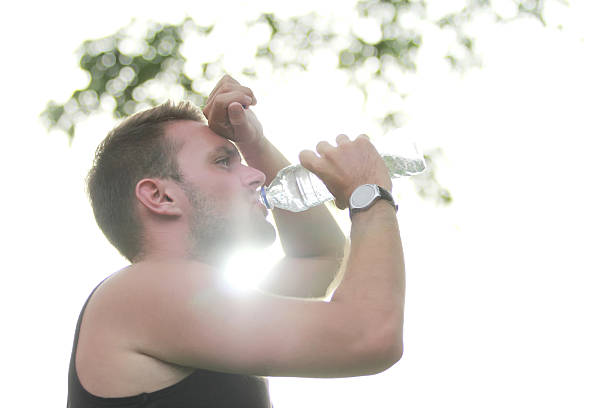 istock male runner drinking mineral water 498400722