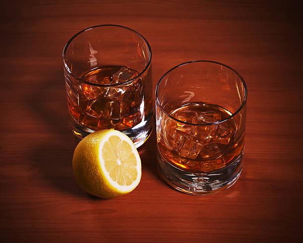 istock Highball whiskey glass with ice and lemon. 498400761