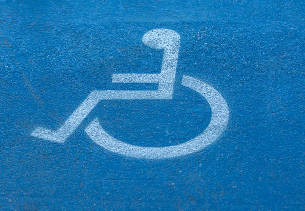 disabled,handicap sign on blue floor stock photo