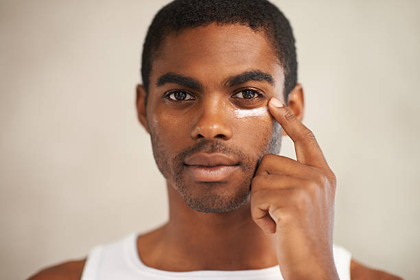 Skincare for the modern man A young man applying face creamhttp://195.154.178.81/DATA/i_collage/pi/shoots/783406.jpg stubble male african ethnicity facial hair stock pictures, royalty-free photos & images