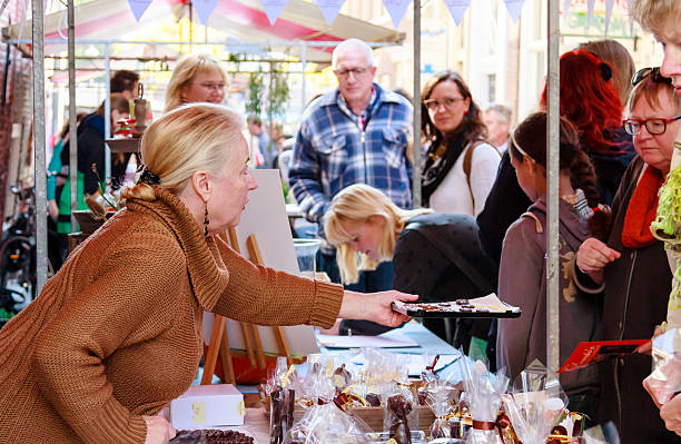 Chocolate samples Dordrecht, Netherlands - September 29 2013: Stall holder offering samples of chocolate to costomers at a market stall during the event Dordt Pakt Uit in the old city center of Dordrecht. dordrecht photos stock pictures, royalty-free photos & images