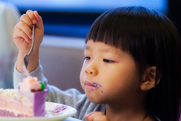 istock Asian birthday girl eating cake 498403709