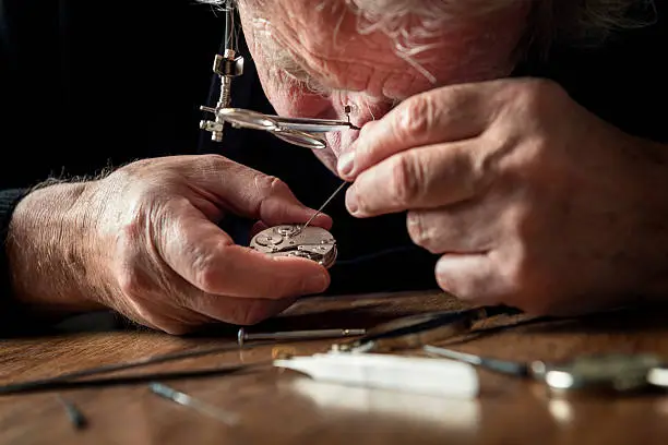 Close up of a watchmaker at work.