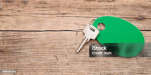 Key With A Blank Label On An Old Wooden Plank Stock Photo - Download Image Now - 2015, Business, Business Finance and Industry