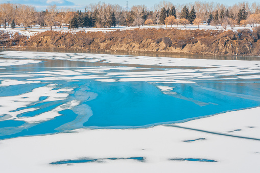 A winter landscape of patterns on an icy Glenmore Reservoir.