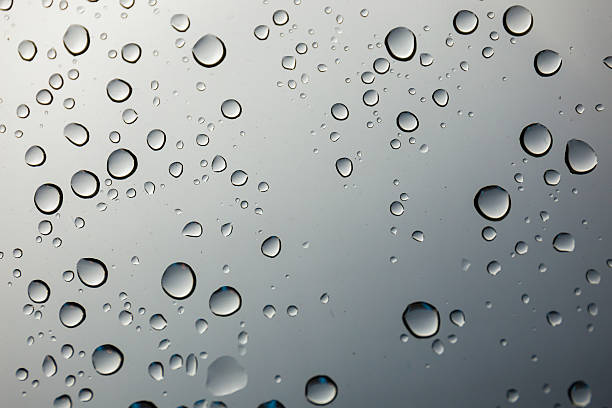istock closeup water drop on glass mirror background. 498407510