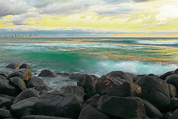 istock Yellow Beach Sunrise with Rocky Foreground 498407954