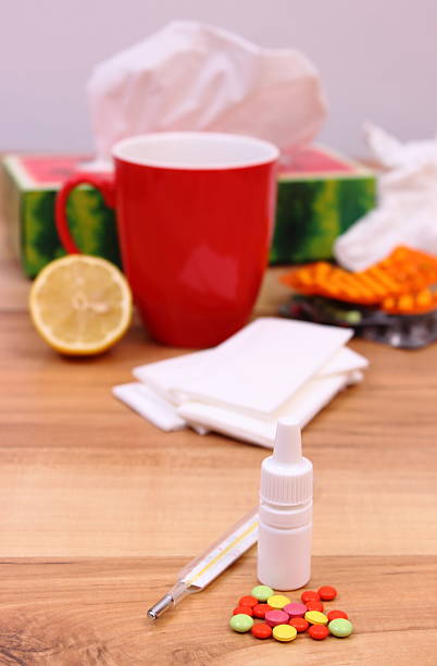 istock Pills and nose drops for colds, used handkerchiefs 498410298