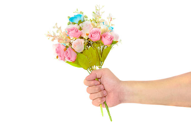 istock Hand holding rose bouquet 498411330