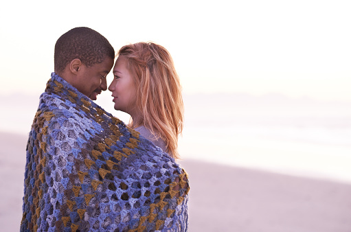 Shot of a loving young couple wrapped in a blanket at the beachhttp://195.154.178.81/DATA/i_collage/pu/shoots/805994.jpg