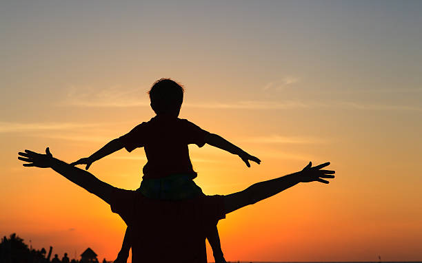 istock father and son having fun at sunset 498420758