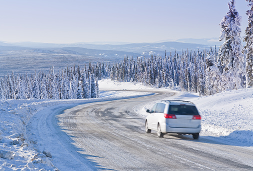Car driving on an Icy Winter Road in Alaska’s  Arctic Wilderness.  Intentional Motion Blur.