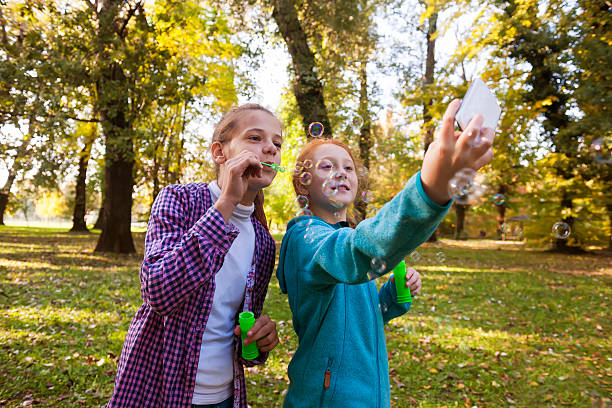 istock Friends blowing bubbles outdoors 498424004