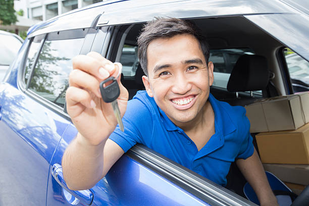 istock Asian man driver smiling and showing car key 498425024