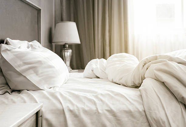 istock Bed sheet mattress Duvet and pillows unmade 498425354