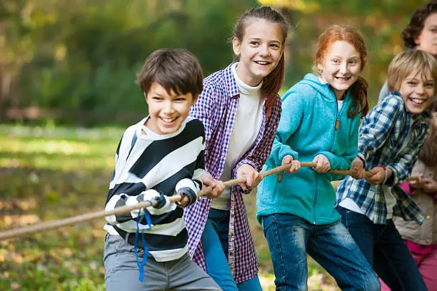 Photo of Group of kids in a tug-of-war game