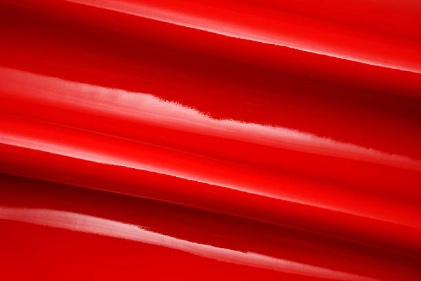 istock Close-up of red shiny vinyl wave texture background 498425551
