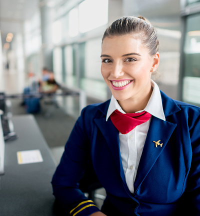 Happy flight attendant ready to start boarding process