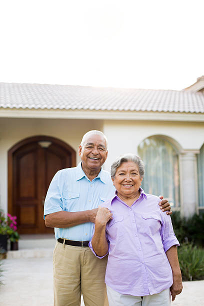 istock Senior couple smiling outside house 498427813