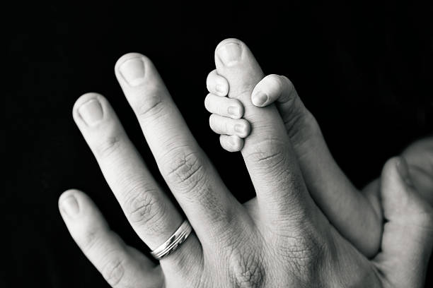 istock Newborn Hand Gripping Father's Finger 498428841