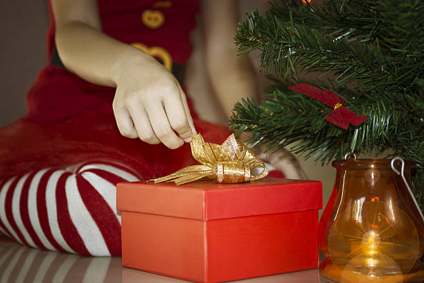 istock Child in striped socks open christmas gift 498430504