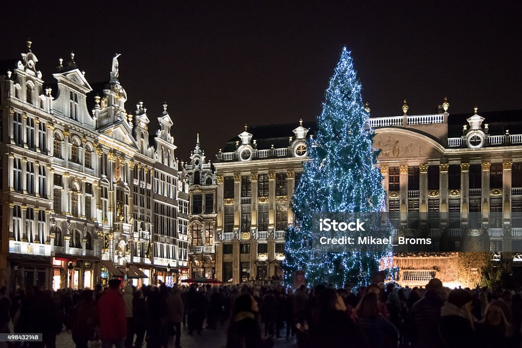 Christmas market at Grand Place, Brussels, Begium Night view of the crowded christmas market at Grand Place in Brussels, Belgium. Illuminated gothic buildings and christmas tree. Christmas Stock Photo