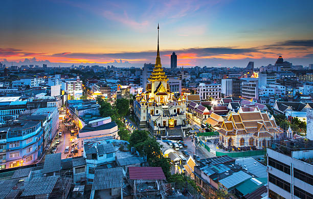 Urban City Skyline with Wat Traimit (Temple) Bangkok, Thailand. stock photo