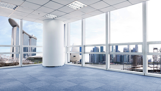 Clean spacious office room interior with city view and daylight. Workplace design concept. 3D Rendering