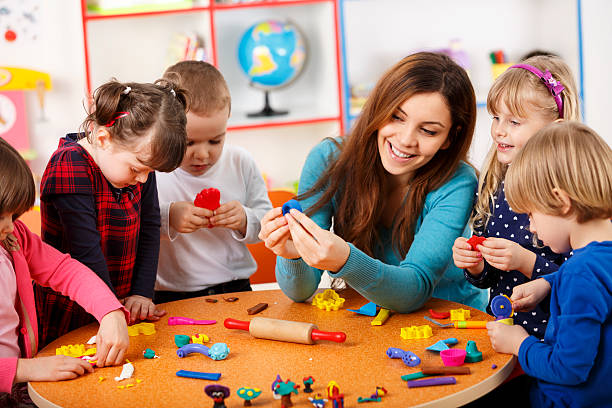 Nursery teacher playing with the kids