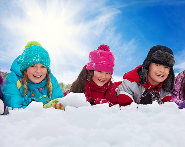 istock Three kids laying in snow 498447691