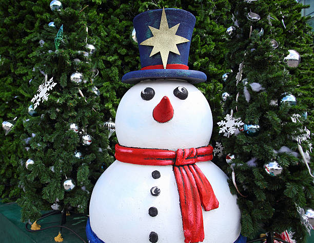 istock Cute little smiling snowman under Christmas tree with snow ball 498448345
