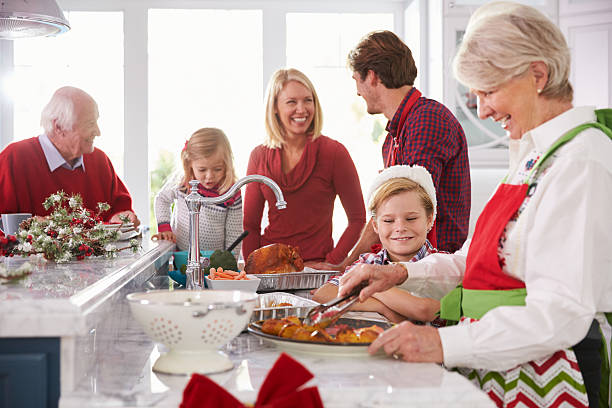 istock Extended Family Group Preparing Christmas Meal In Kitchen 498452124