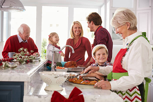 istock Extended Family Group Preparing Christmas Meal In Kitchen 498452290