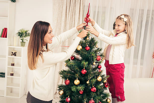 istock Mother And Dughter Decorating Christmas Tree 498452388