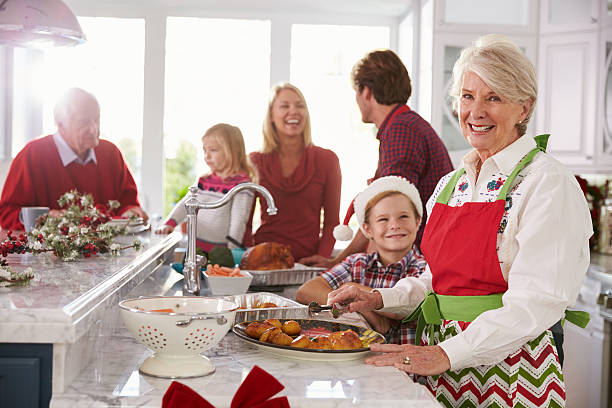 istock Extended Family Group Preparing Christmas Meal In Kitchen 498452610